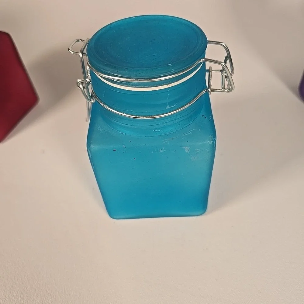 Set Of Four Colored‎ Glass Cannisters With Locking Tops Very Good Condition